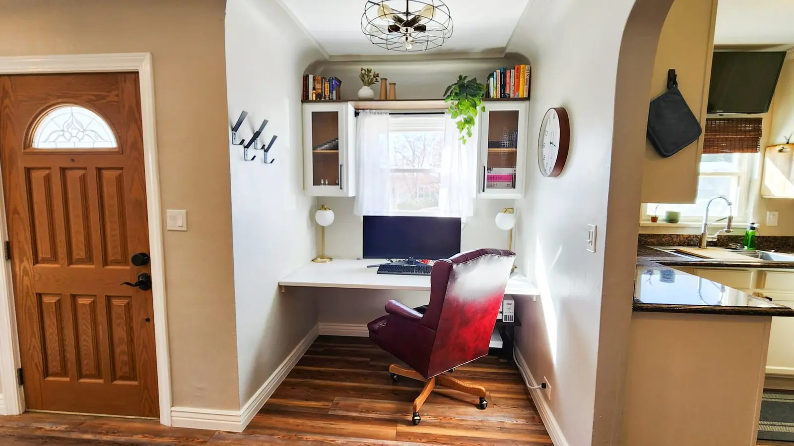 The dedicated workspace at The Elati House with a desk, monitor and leather chair