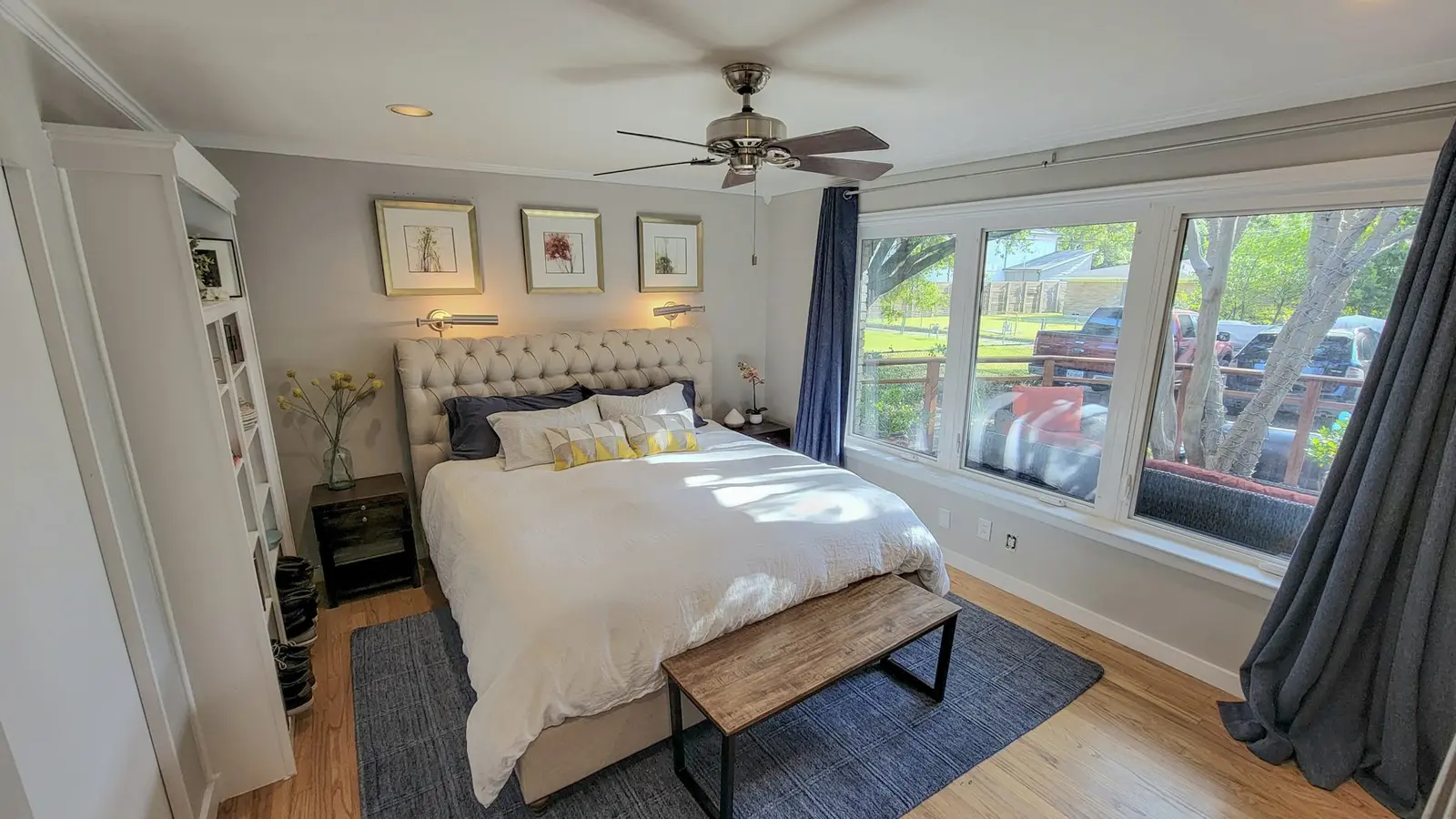 The main bedroom at The McCosh House with a tufted headboard and a bench at the foot of the bed